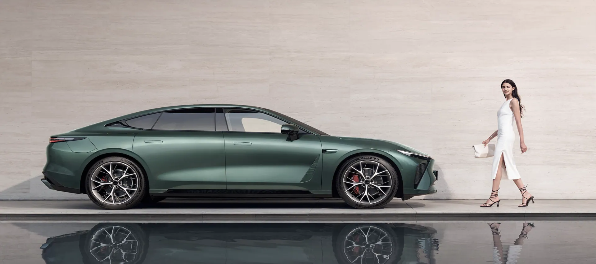 EXEED ES luxury sedan reflected in still water against stone architecture